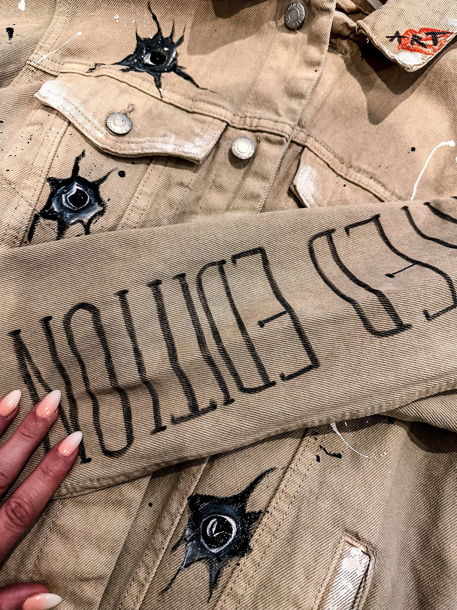Hand-painted denim jacket sleeve detail lettering Rhino Art