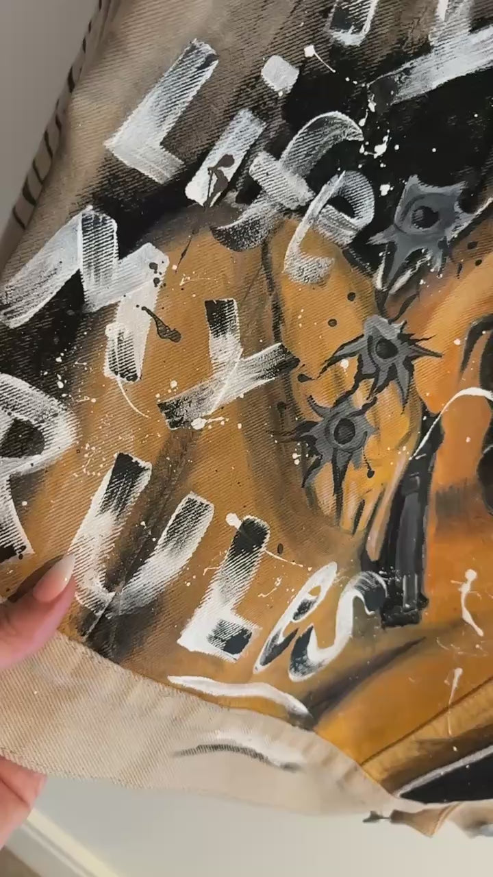Close-up hand-painted denim jacket artwork process Rhino Art