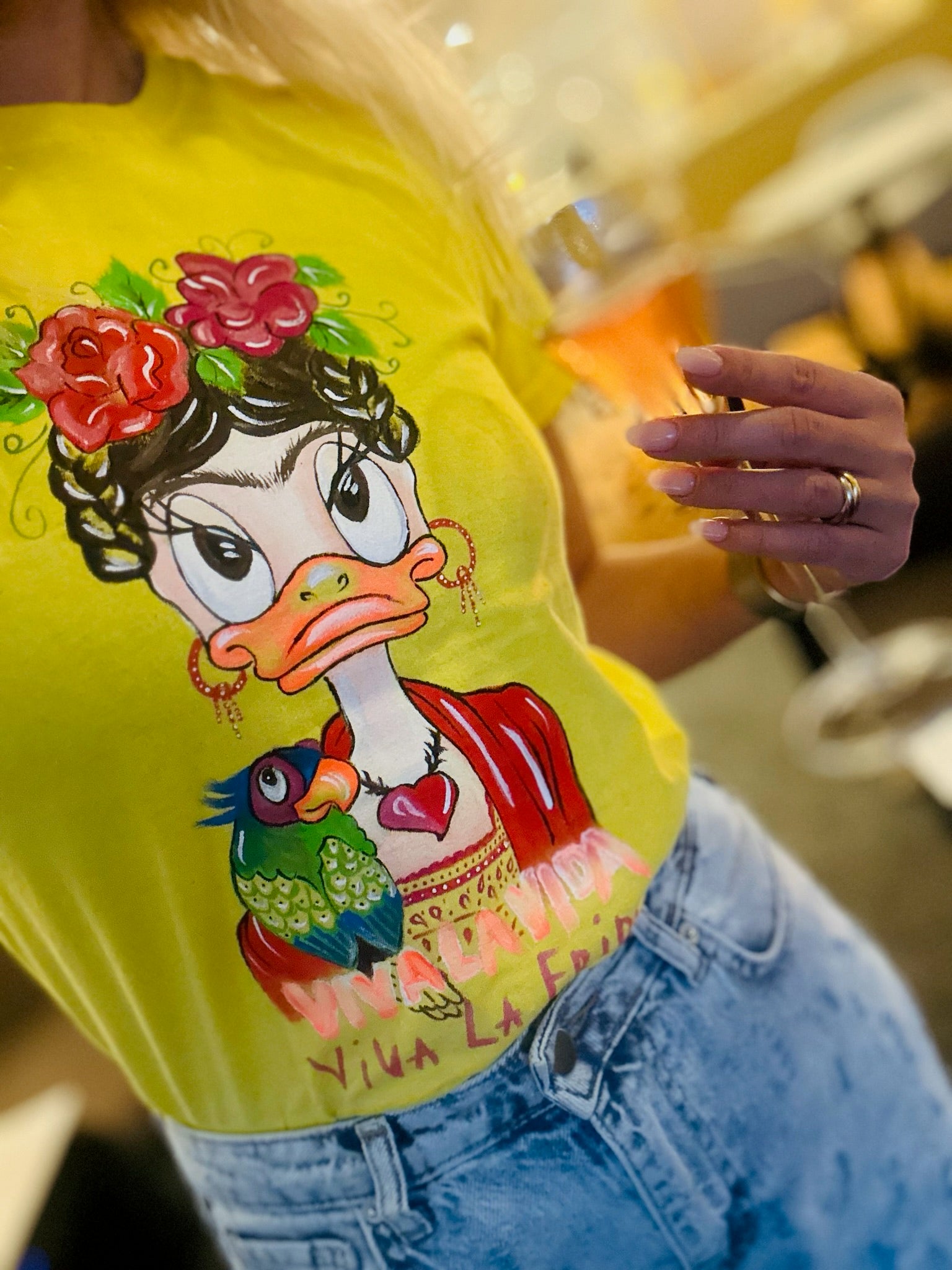 Close up hand painted artwork on yellow t-shirt